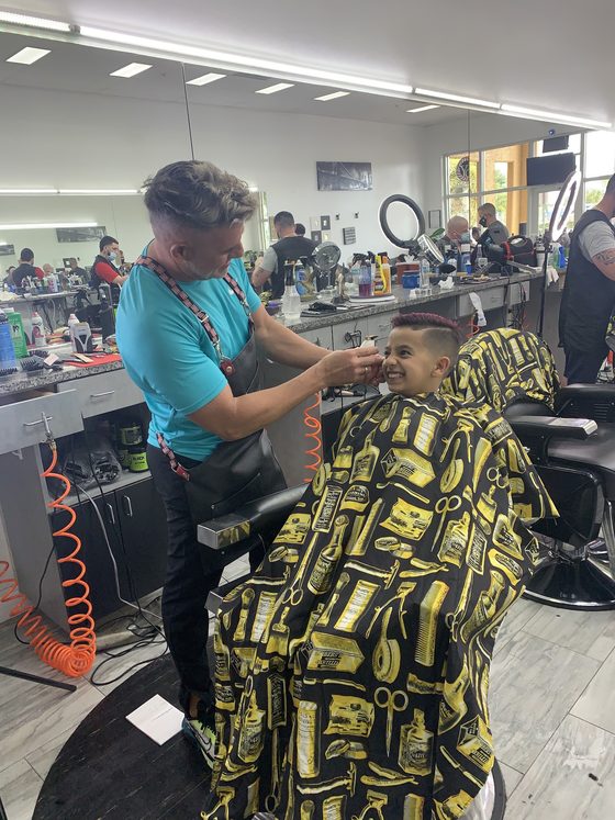 Barber finishing a client's fade in the chair at Yovany Barbershop #1, Cape Coral FL