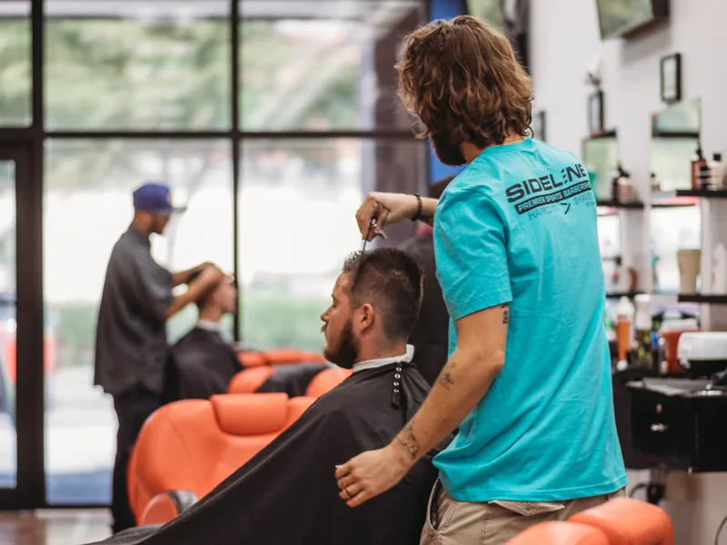 Barber working on a client at the North Port studio